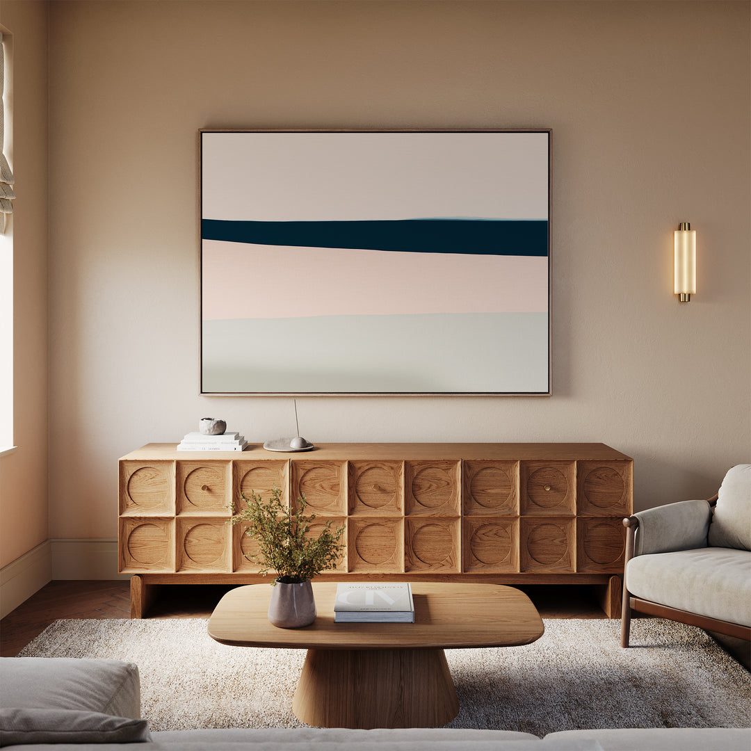 A modern living room with a wooden sideboard, neutral-toned sofa, soft rug, warm lighting, and the Coastal Blend Canvas Art – Horizontal as minimalist wall decor for a stylish and minimal look.