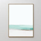 Coastal Breeze Abstract Canvas Art showcases a serene seascape with turquoise waters, sandy shore, and white sky, framed in light wood—perfect minimalist coastal wall art for elevating your living room decor.