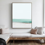 Minimalist living room with light wood furniture and neutral cushions, featuring the Coastal Breeze Abstract Canvas Art—a large piece in white, blue, and beige tones—bringing serene coastal vibes to your decor.