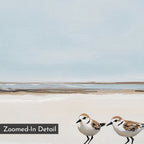 The "Coastal Chase Canvas Art" showcases two small shorebirds on a sandy beach under a calm blue sky with gentle waves. A "Zoomed-In Detail" label appears in the lower-left corner of this serene, minimalist coastal wall art print.
