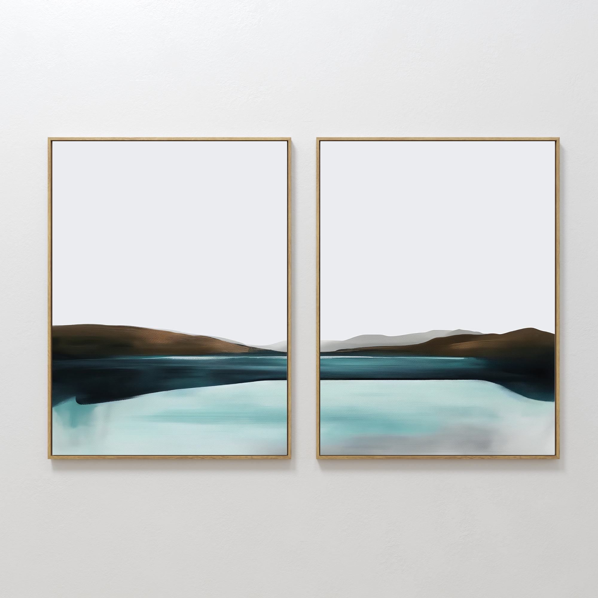 The Coastal Calm Set of 2 features framed abstract landscape paintings with cool tones, showing a serene body of water and distant hills, displayed side by side on a white wall.