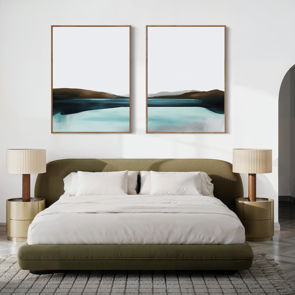 A modern bedroom with a green upholstered bed, white bedding, beige nightstands and lamps, and the “Coastal Calm Set of 2” abstract landscape paintings above the bed. A neutral palette and minimalist style create a serene retreat.