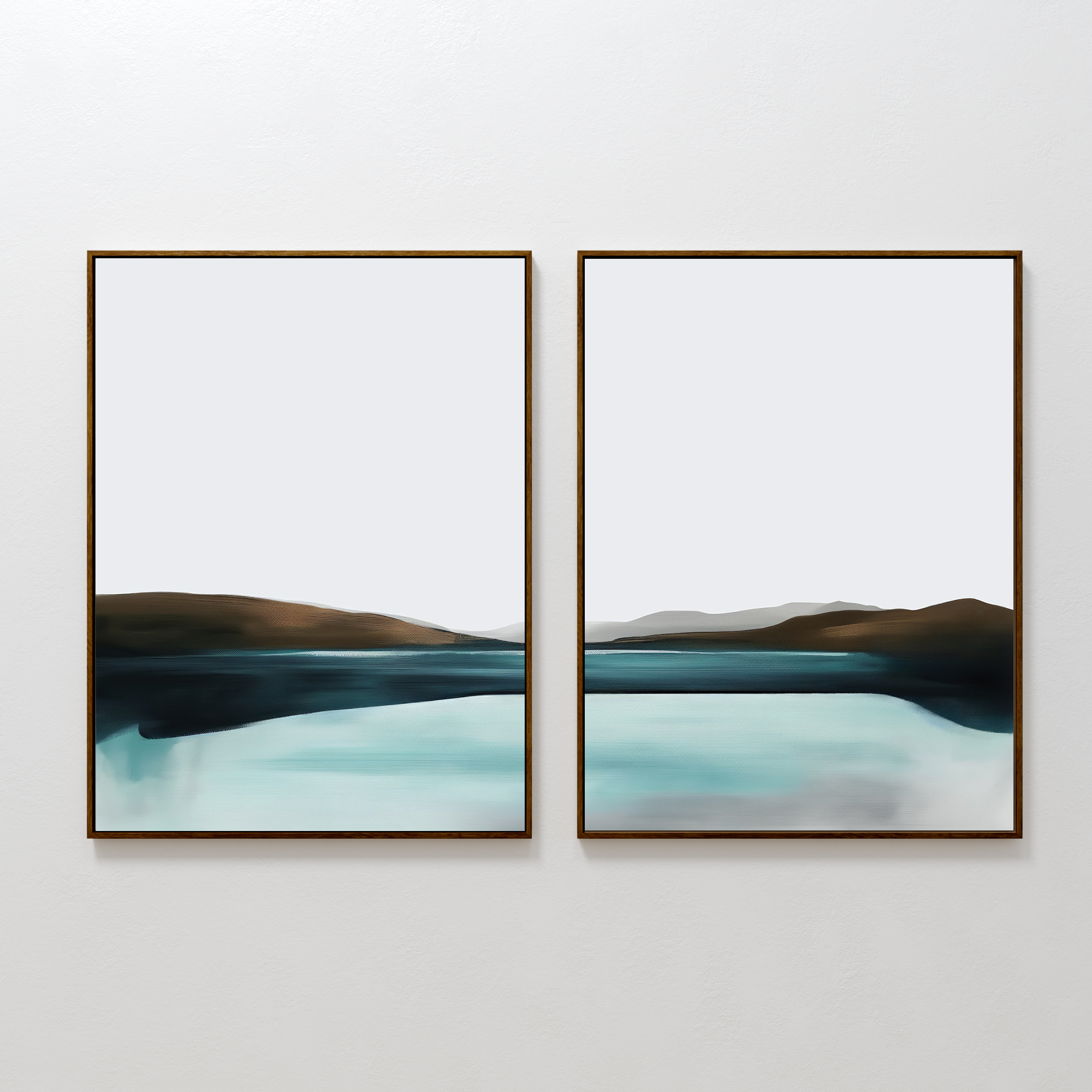 The Coastal Calm Set of 2 features framed abstract paintings side by side, showcasing a serene landscape with a blue-green body of water, brown hills, and a pale gray sky on a white wall.