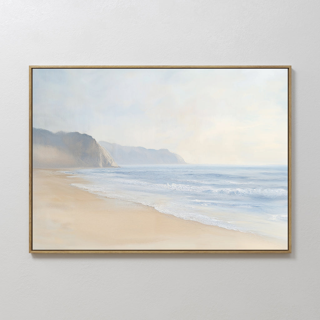Coastal Cliffs Canvas Art features a serene beach landscape with gentle waves and distant cliffs beneath a soft, cloudy sky, adding tranquil beauty to any modern home decor.