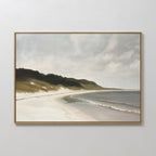 The Coastal Silence Canvas Art features gentle waves on a sandy beach with grassy dunes and dark green trees beneath a cloudy sky, creating a serene landscape print that brings calm and tranquility to any room.