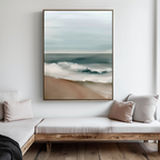 A minimalist living room with light wood furniture and neutral cushions features Coastal Whisper Abstract Canvas Art as a focal point, the framed ocean-inspired piece standing out against a crisp white wall.
