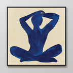 Cobalt Figure Canvas Art: Minimalist canvas with a blue silhouette of a seated figure, legs crossed and arms raised behind the head on a beige background in a black frame—a stylish touch for modern wall decor.