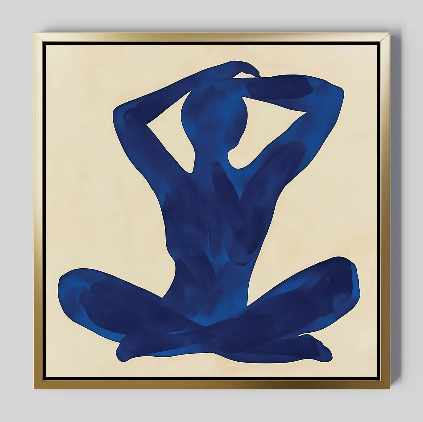 Cobalt Figure Canvas Art: A minimalist canvas showing a blue silhouette in a seated yoga pose with raised arms and hands on the head, set against a beige background and framed in gold—a bold piece of modern wall art.