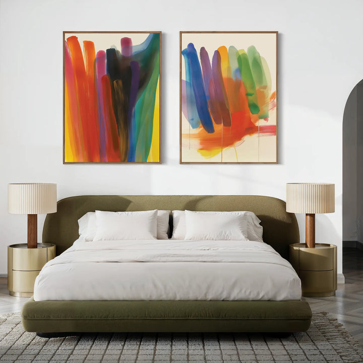 A modern bedroom with an olive green bed, white bedding, two beige nightstands with matching lamps, and the Color Cascade Set of 2 abstract wall art hanging above the bed.