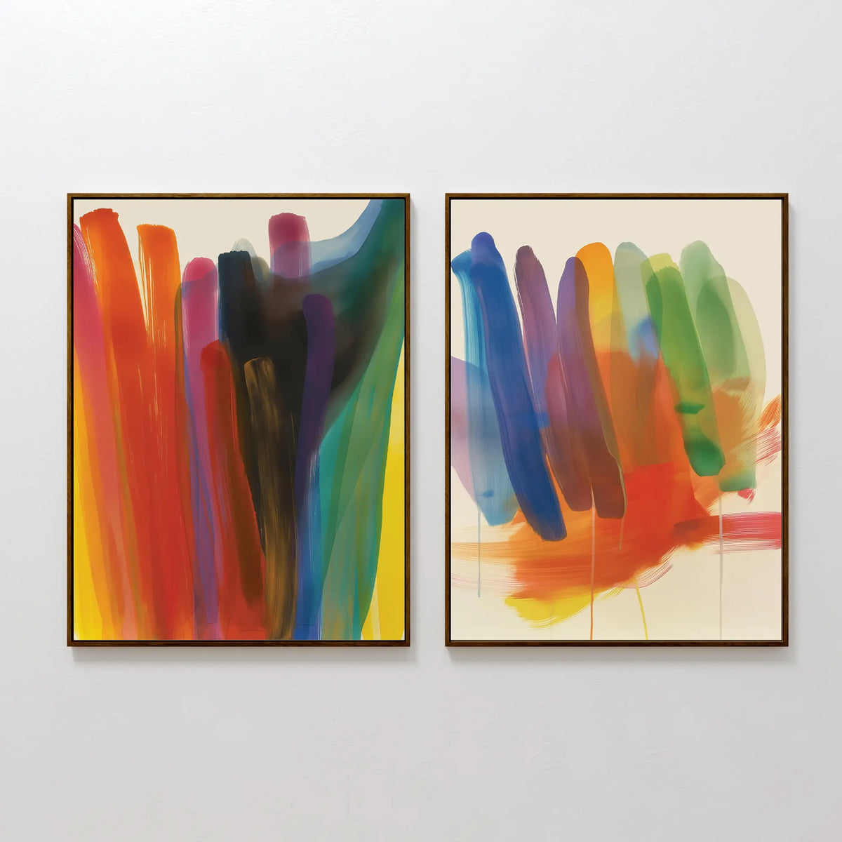 The Color Cascade Set of 2 features framed abstract wall art with vibrant brushstrokes in red, orange, yellow, blue, green, and purple—ideal for modern decor and displayed side by side on a white wall.