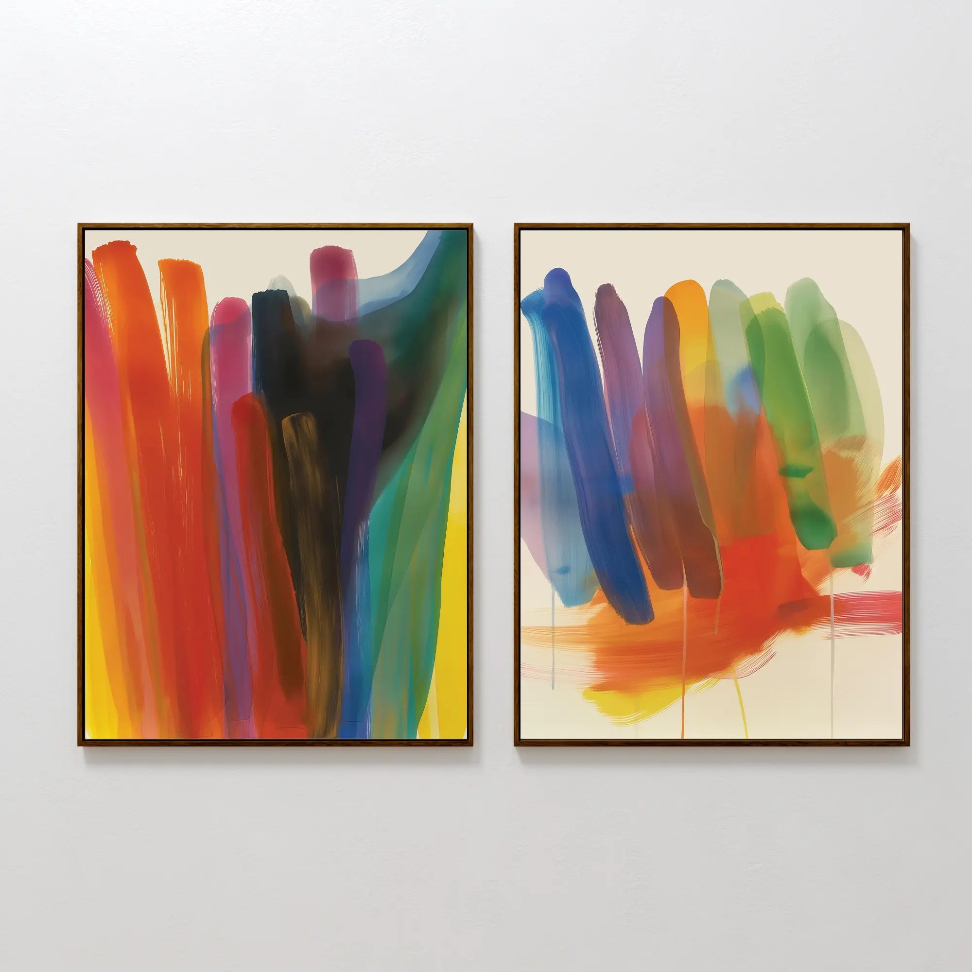 The Color Cascade Set of 2 features framed abstract wall art with vibrant brushstrokes in red, orange, yellow, blue, green, and purple—ideal for modern decor and displayed side by side on a white wall.