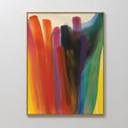 Color Cascade Abstract Canvas Art showcases broad, vertical brushstrokes in red, orange, yellow, purple, blue, green, and black on a light background. This vibrant framed piece is displayed on a plain white wall.