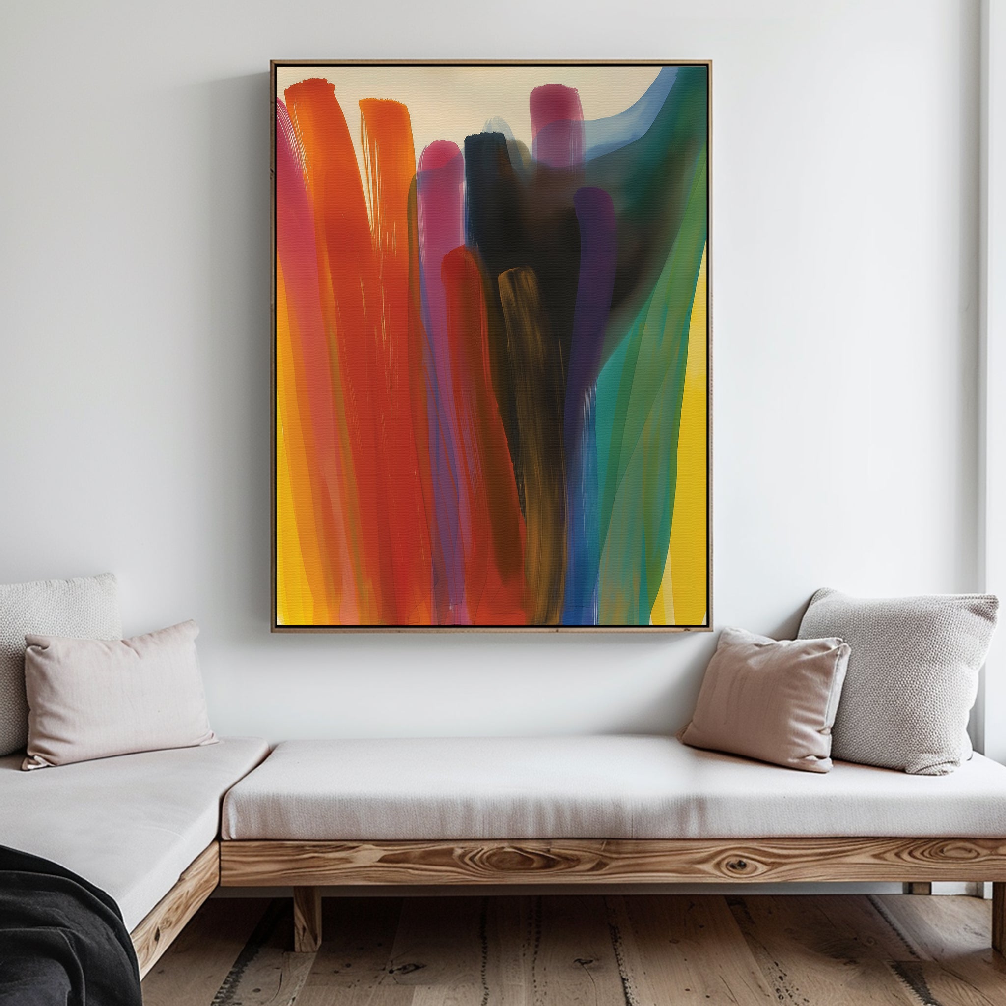 A modern living room displays the Color Cascade Abstract Canvas Art, featuring bold red, blue, yellow, purple, and black brushstrokes. A wooden bench with light cushions complements the neutral, minimalist decor.