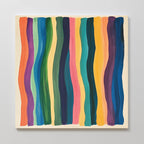 Color Flow Canvas Art features vertical, wavy stripes in orange, purple, blue, green, pink, and yellow on a light beige background. This abstract piece brings a vibrant flow to modern living room décor.