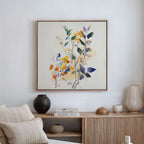 The Colorful Branches Canvas Art hangs above a wooden sideboard adorned with neutral vases, books, and dried grasses, creating a cozy living room featuring a beige cushioned bench and stylish modern decor.