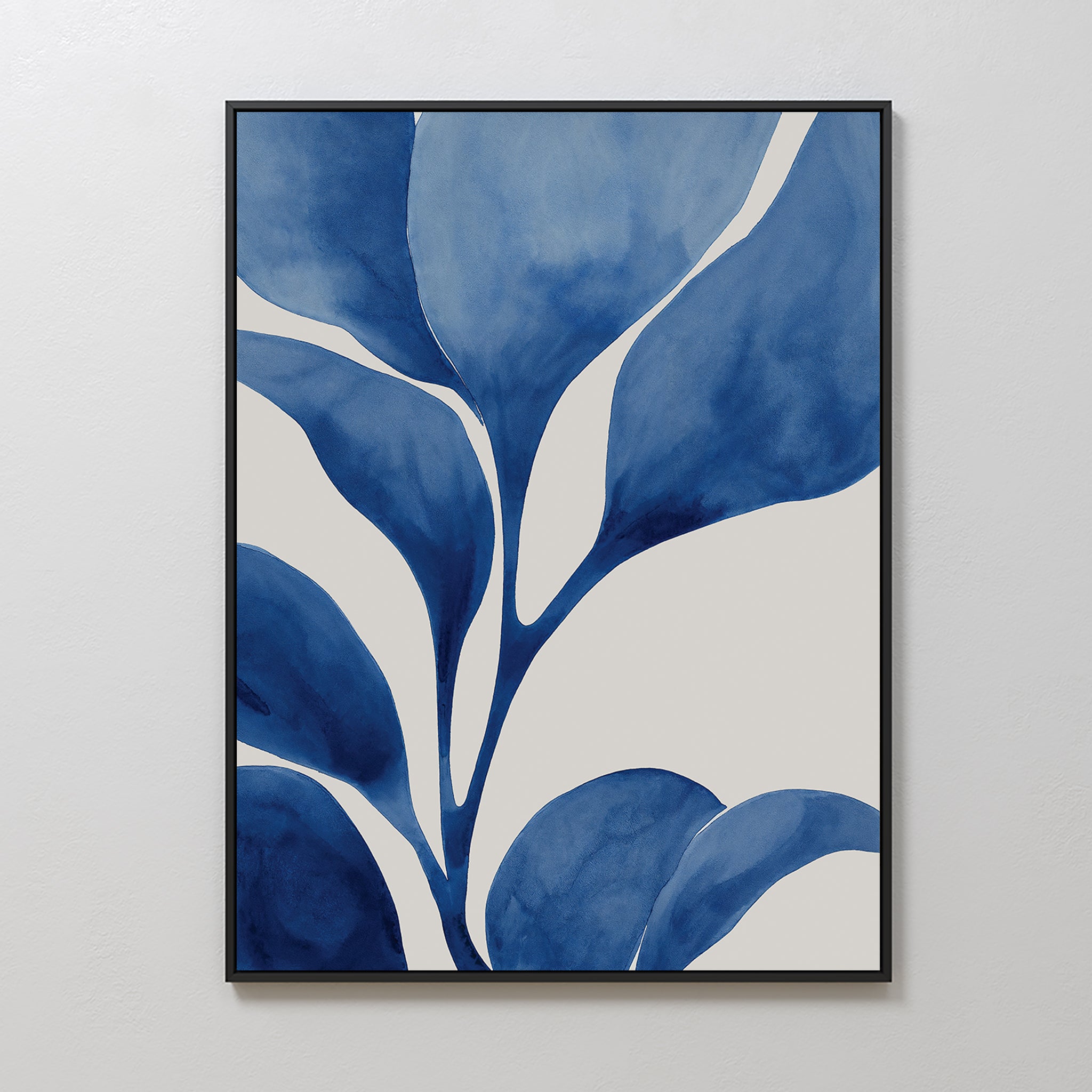 The Cool Tangle Canvas Art showcases abstract, oversized blue leaves with white negative space, creating a minimalist and modern botanical design. Displayed on a plain white wall, it adds a contemporary touch to any space.