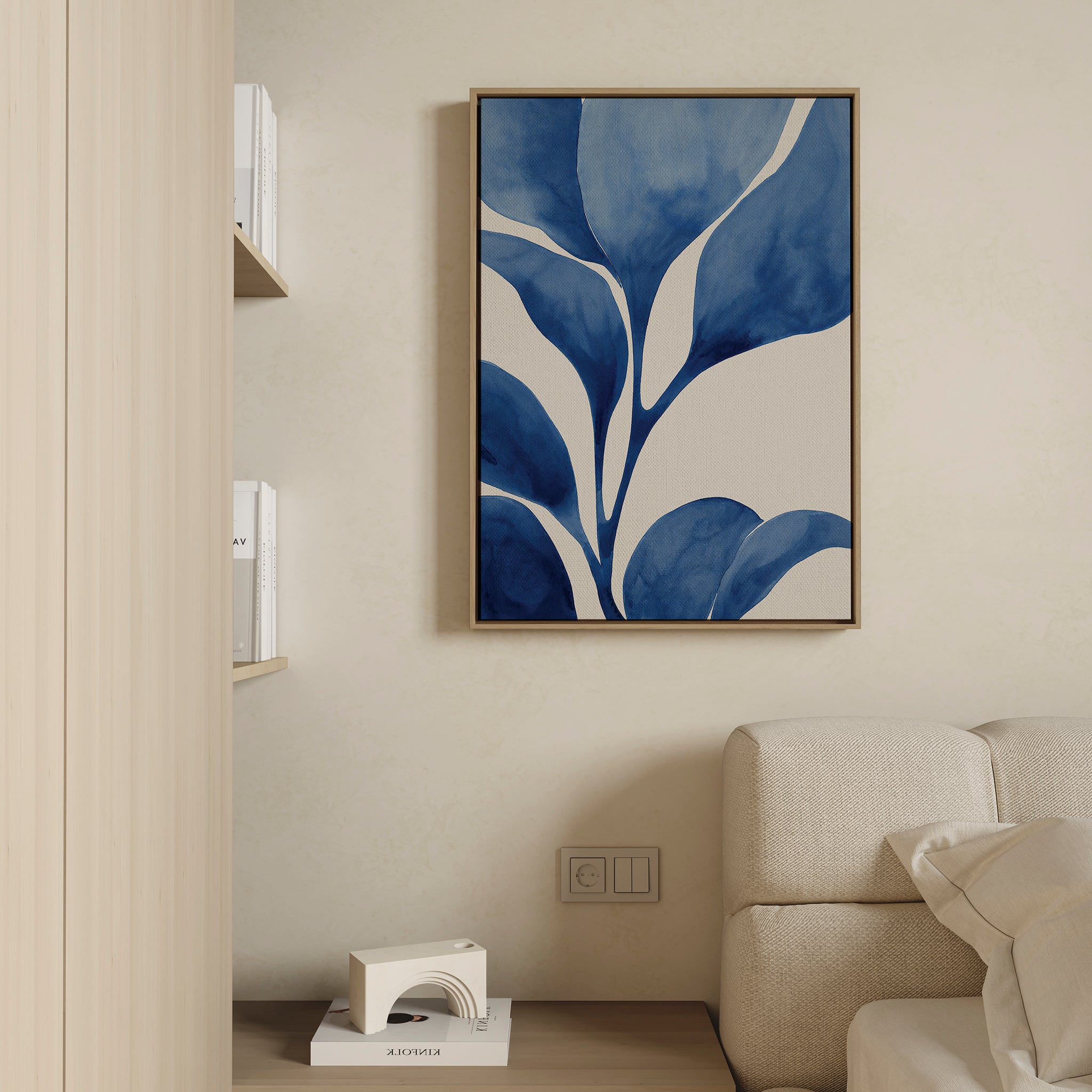 A modern living room with a beige couch, light wood walls, bookshelves, and the striking Cool Tangle Canvas Art displayed above an electrical outlet.