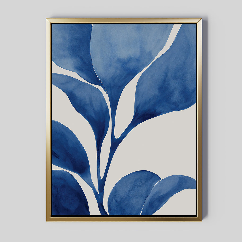 Cool Tangle Canvas Art is a framed abstract botanical painting showcasing large blue watercolor leaves on a white background, accented by a sleek gold frame for a modern, minimalist look.