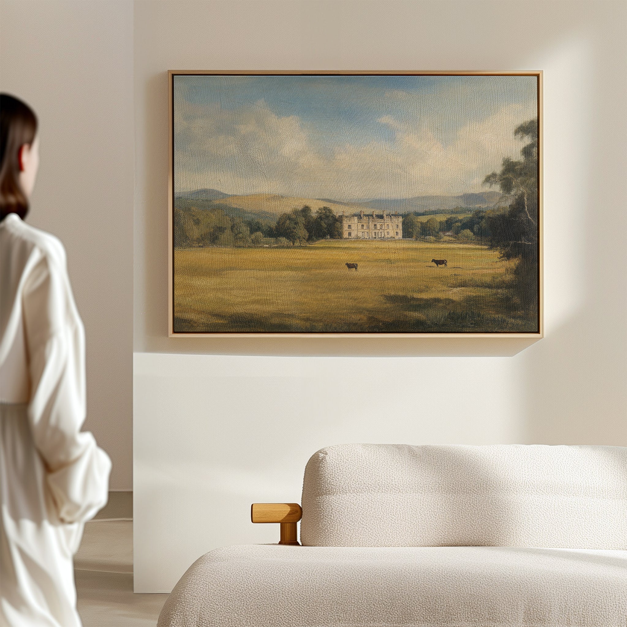 A woman admires the Countryside Dream Canvas Art displayed on a wall.