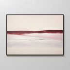 Crimson Horizon Abstract Canvas Art showcases a horizontal band of deep red over soft pink and white tones, framed in black—ideal modern wall art for living room decor on a light-colored wall.