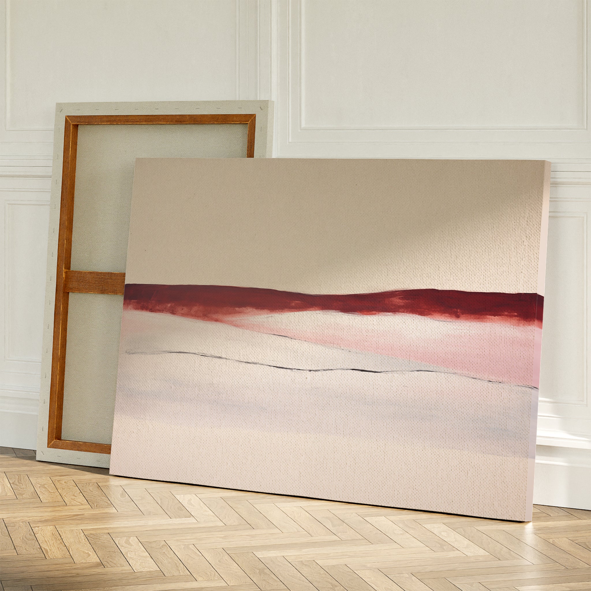 Two large canvases lean against a white wall; one reveals its blank back, while the other features the Crimson Horizon Abstract Canvas Art with red and pink horizontal brushstrokes on a neutral background—ideal for modern decor.