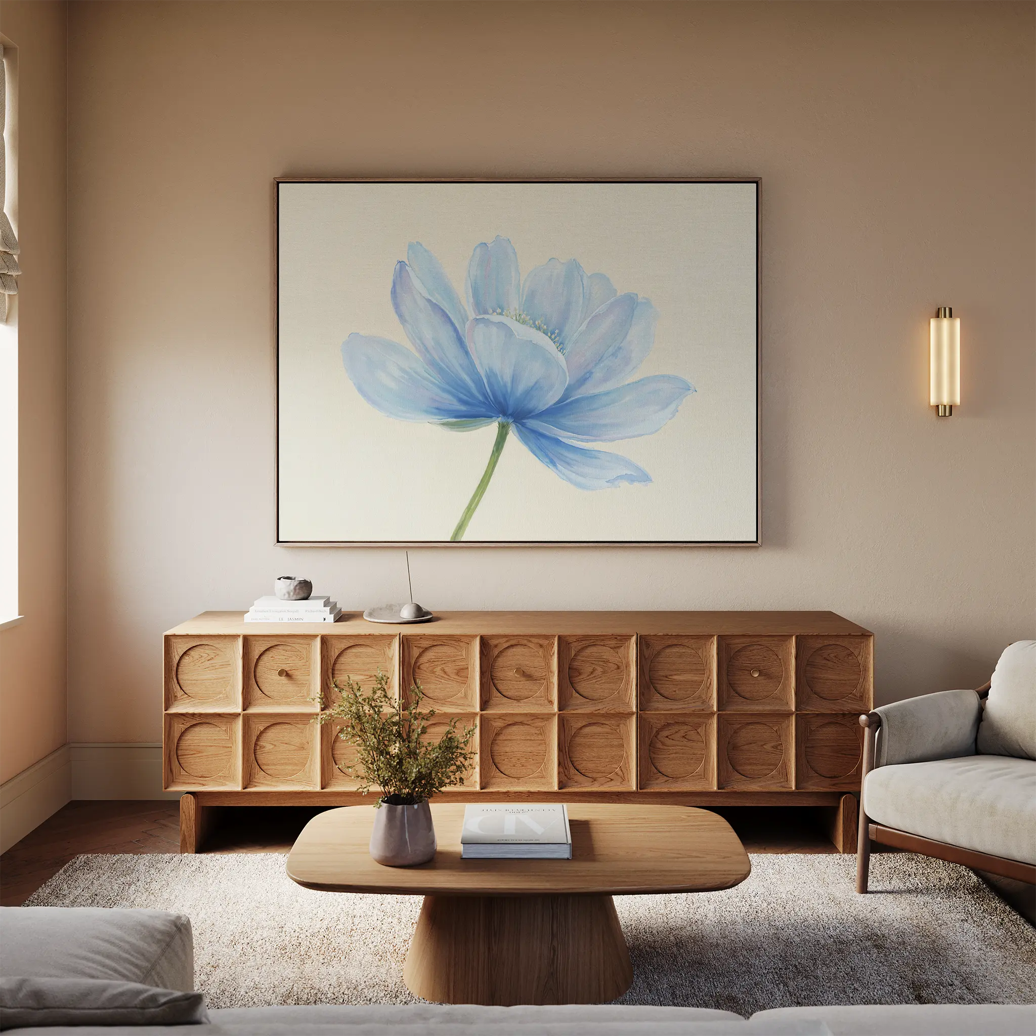 A modern living room with a light wood sideboard, a beige sofa, wooden coffee table with flowers, and the Daybreak Flower Canvas Art as minimalist wall decor above the sideboard, all illuminated by soft natural window light.
