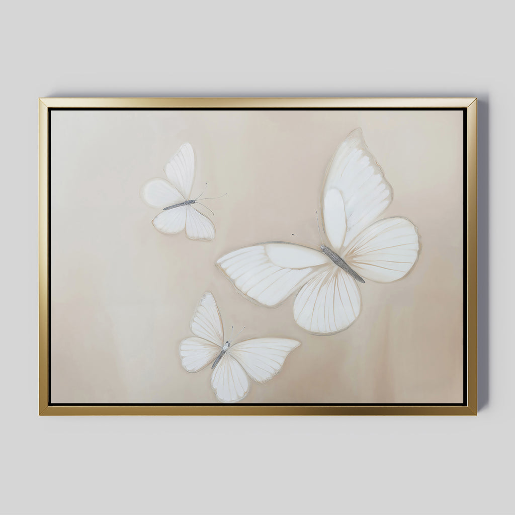 The Delicate Whites Canvas Art displays three white butterflies with delicate wings on a light beige background, elegantly framed in gold—a stylish piece of neutral wall decor.