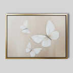 The Delicate Whites Canvas Art displays three white butterflies with delicate wings on a light beige background, elegantly framed in gold—a stylish piece of neutral wall decor.