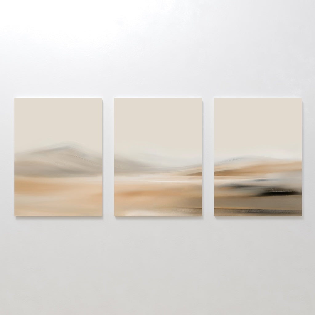 The Desert Haze Set of 3 features abstract canvas paintings with soft, blurred beige, tan, and brown tones, creating calming minimalist wall art ideal for living room decor.