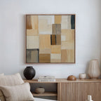 The Desert Mosaic Abstract Canvas Art hangs above a light wooden sideboard decorated with vases, a bowl, and stacked books, adding neutral geometric style to minimalist living room decor.