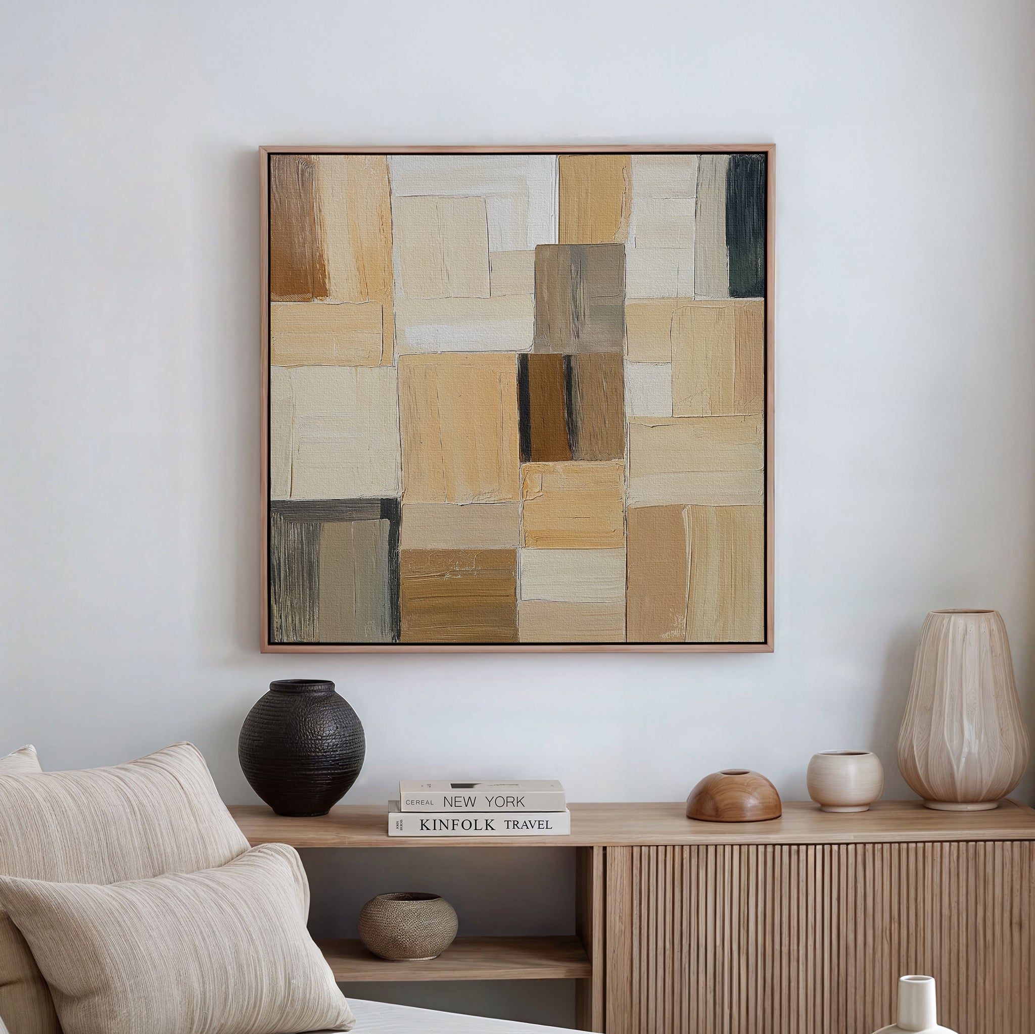The Desert Mosaic Abstract Canvas Art hangs above a light wooden sideboard decorated with vases, a bowl, and stacked books, adding neutral geometric style to minimalist living room decor.
