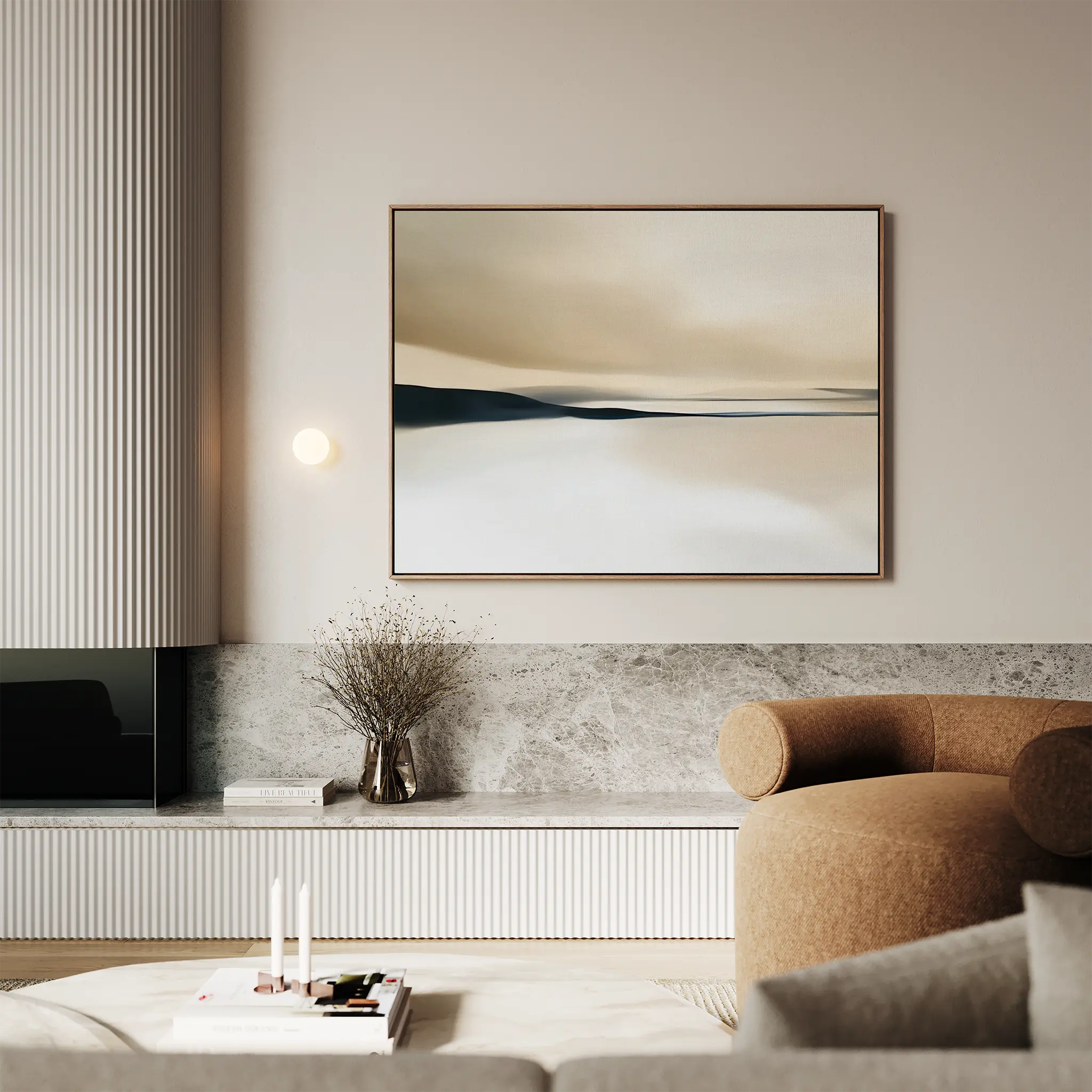 A modern living room with a beige curved sofa, marble accents, and the Desert Quietude Canvas Art – Horizontal in neutral tones above a built-in shelf adorned with refined décor.