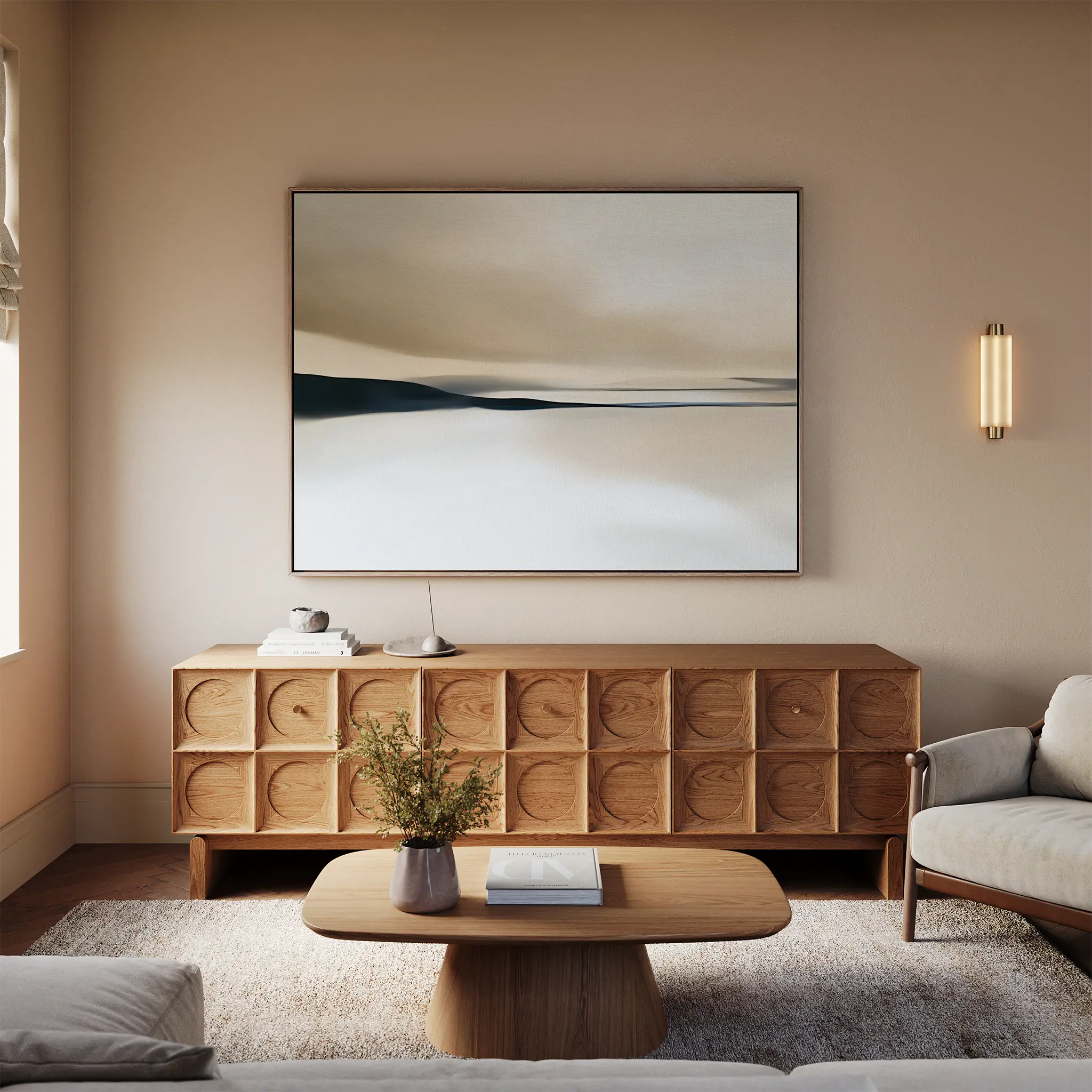 A modern living room with neutral walls, a light beige sofa, wooden coffee table, and sideboard. The Desert Quietude Canvas Art – Horizontal hangs above the sideboard, enhancing the decor along with a soft light fixture.