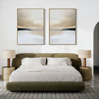 A modern bedroom featuring an olive green upholstered bed with white bedding, beige nightstands with matching lamps, a gray textured rug, and the Desert Quietude Set of 2 minimalist wall art above the headboard inspired by abstract desert landscapes.