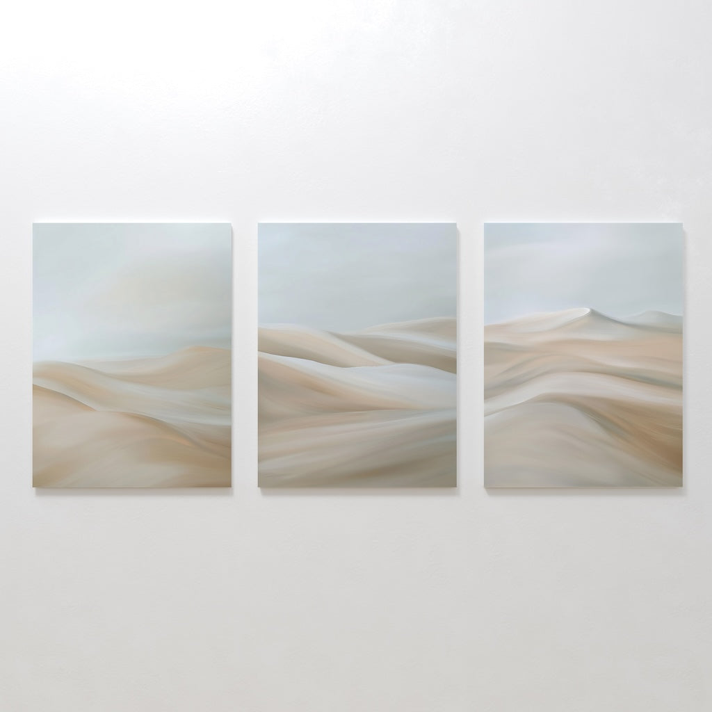 The Desert Serenity Set of 3 features abstract canvas panels with soft beige and light gray desert dunes, mounted side by side—perfect minimalist wall art for your living room.