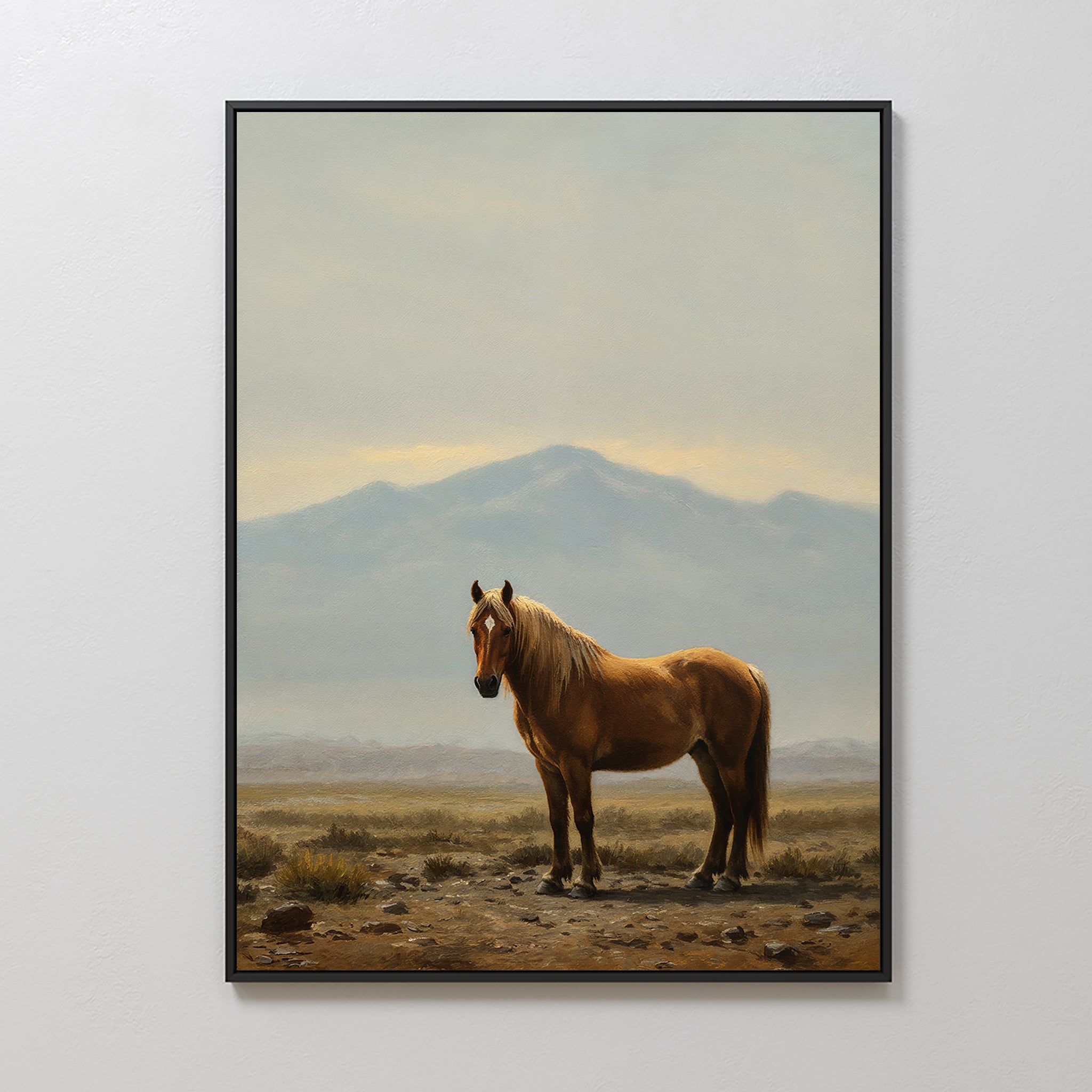Desert Watch Canvas Art showcases a chestnut horse on rocky ground with distant mountains and a cloudy sky, making striking wall decor on a white wall—ideal for fans of desert art or classic Nordic Park-inspired interiors.