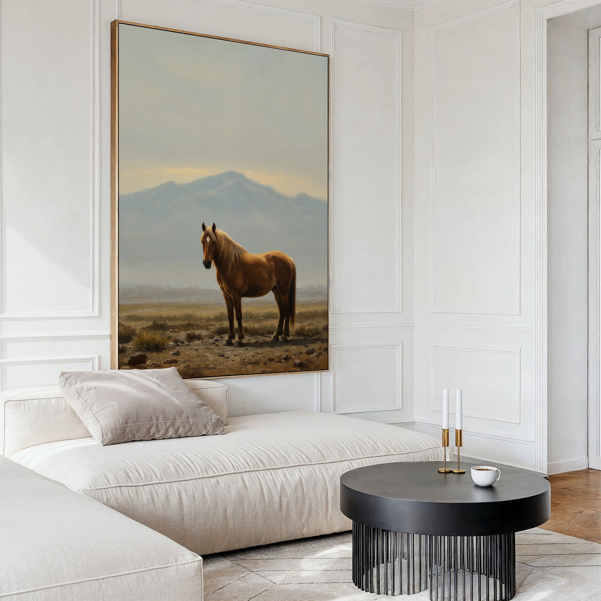 A modern living room with a white sectional sofa, beige cushions, a round black coffee table, and the Desert Watch Canvas Art featuring a chestnut horse and mountain backdrop brings Nordic Park-inspired elegance to the space.