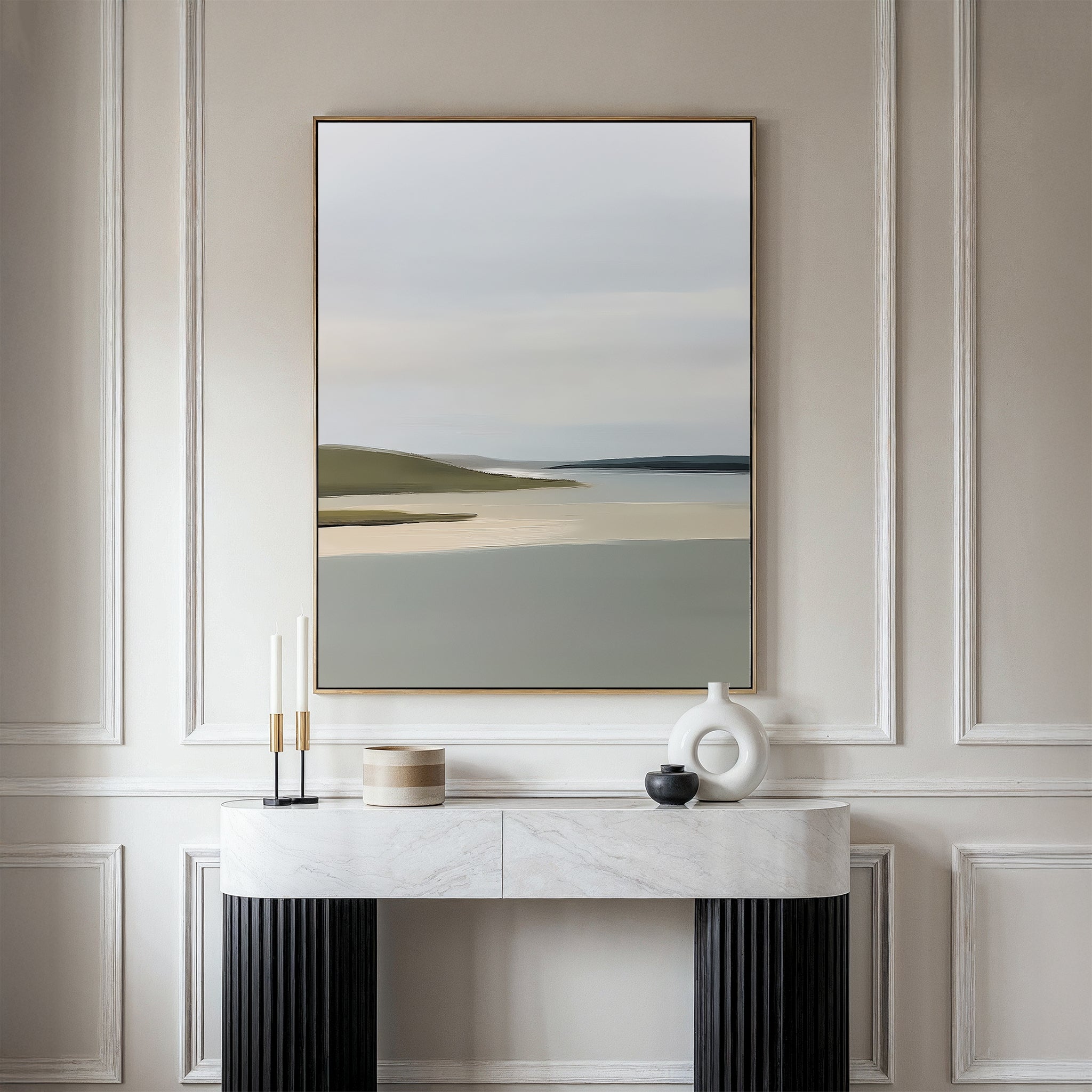 A minimalist console table with decor stands against an elegant, light-paneled wall. Above it hangs the Distant Shores Canvas Art, showcasing a serene landscape of soft water and rolling hills for a touch of nature-inspired style.