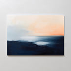 Dusk Ridge Canvas Art features dark blue and black brushstrokes at the base, blending into lighter blue, white, and soft peach tones above—a tranquil wall art piece that evokes a serene sunset seascape for your bedroom decor.