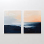 The Dusk Ridge Set of 2 features square abstract paintings with soft, blurred dark blue, white, and peach tones—an abstract landscape art set evoking a serene sky and water, perfect for tranquil bedroom decor.
