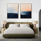 A modern bedroom featuring an olive green bed with white bedding, beige nightstands and lamps, a gray patterned rug, and the calming Dusk Ridge Set of 2 abstract landscape paintings above the bed.