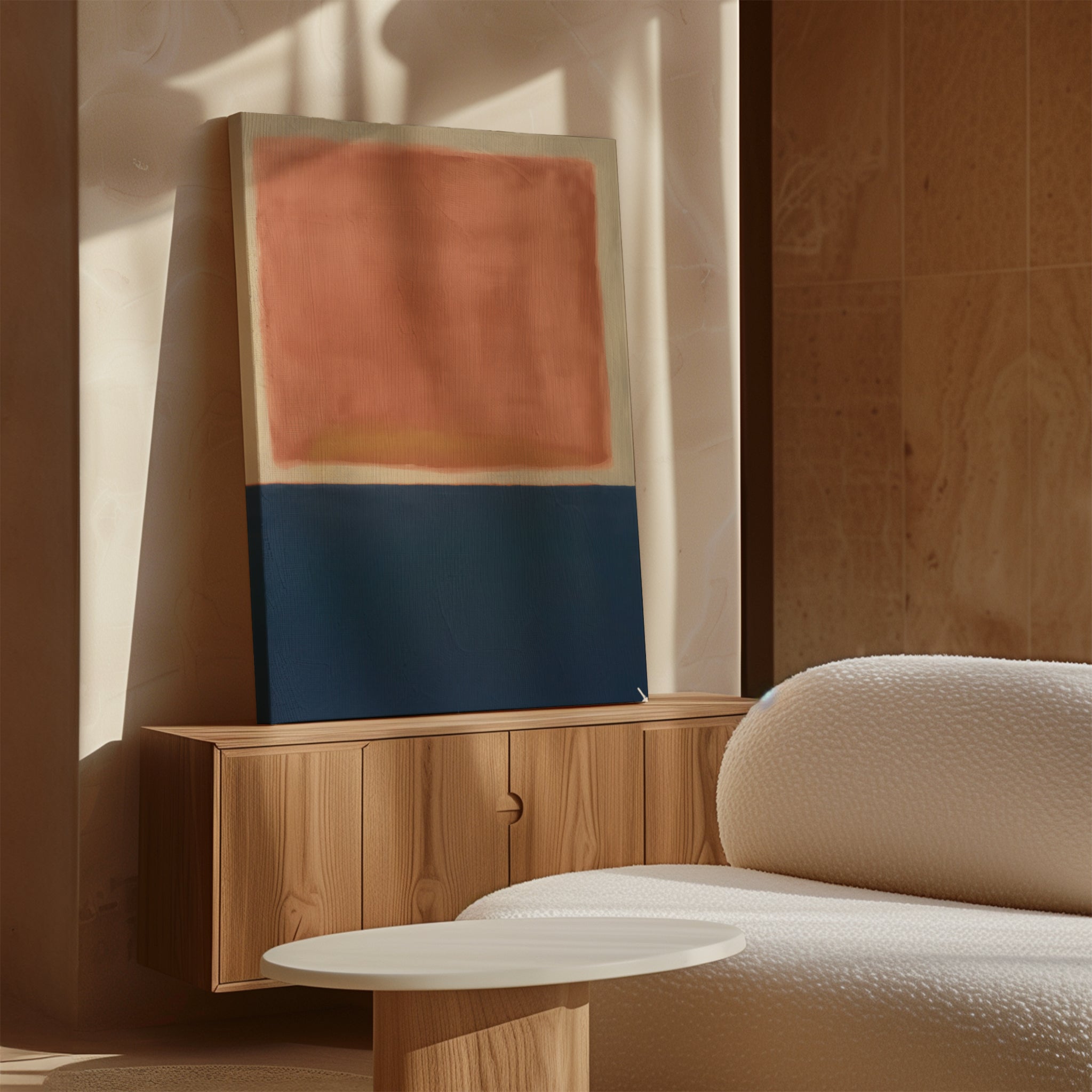 A minimalist room features a textured white sofa, a light round coffee table, and a wooden sideboard displaying the Dusk Stripe Abstract Canvas Art with bold red and dark blue tones. Sunlight casts soft shadows across the space.