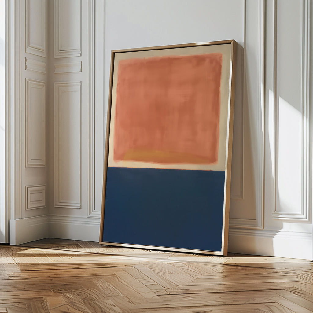 The Dusk Stripe Abstract Canvas Art, featuring a large reddish-orange block above a dark blue block, leans against a white paneled wall on a wooden floor in a sunlit room.