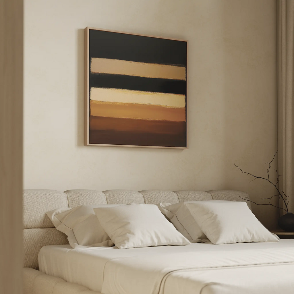 A modern bedroom features a beige headboard bed with white bedding and pillows, accented by the Earth Layers Canvas Art—an abstract piece with black, cream, and brown stripes—hanging above the bed.
