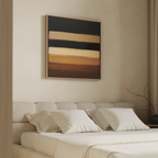 A modern bedroom features a beige headboard bed with white bedding and pillows, accented by the Earth Layers Canvas Art—an abstract piece with black, cream, and brown stripes—hanging above the bed.