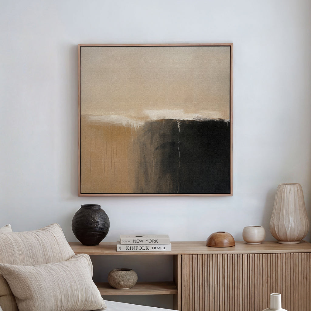 A minimalist living room with neutral decor features a beige couch, a wooden sideboard, and Earthy Cliffs Abstract Canvas Art in beige, white, and black as striking wall art above the seating area.