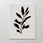 Ebony Leaf Canvas Art: A minimalist print featuring a bold black leafy branch silhouette on a white background. This botanical wall art adds simple elegance and modern style to any interior.
