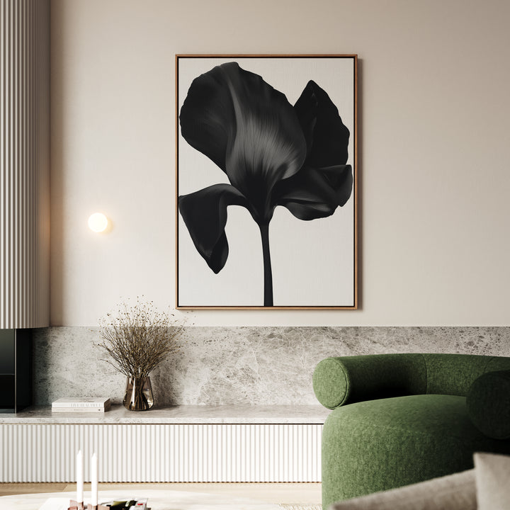 A modern living room features a green sofa, marble-topped console, and the Eclipse Bloom Canvas Art—a large black-and-white floral piece—hanging above, with a vase of dried flowers to complete the elegant decor.