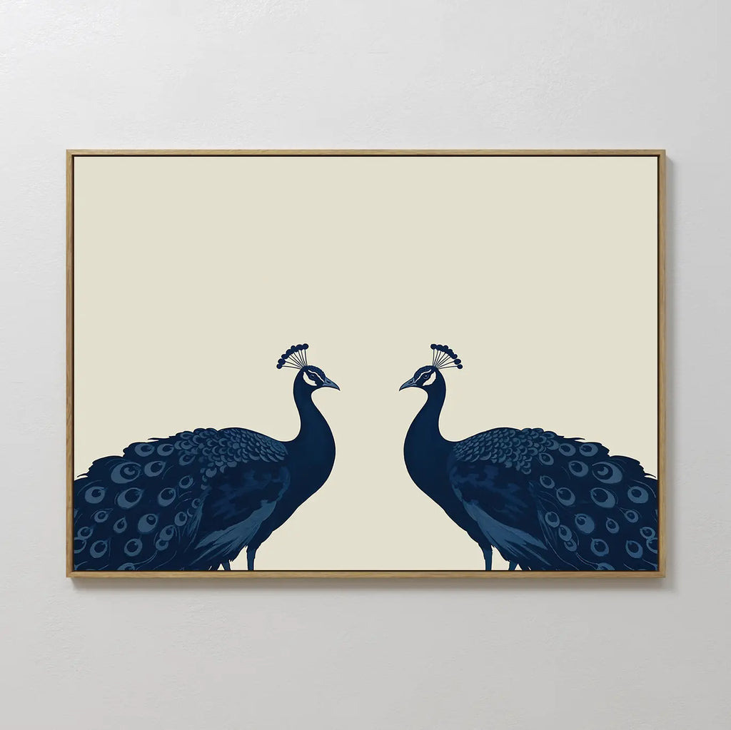 Elegant Plumage Canvas Art showcases two dark blue peacocks facing each other on a light beige background, with detailed feathers and crests—perfect for adding a striking, minimalist touch to your living room decor.