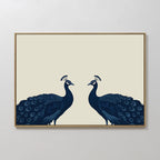 Elegant Plumage Canvas Art showcases two dark blue peacocks facing each other on a light beige background, with detailed feathers and crests—perfect for adding a striking, minimalist touch to your living room decor.